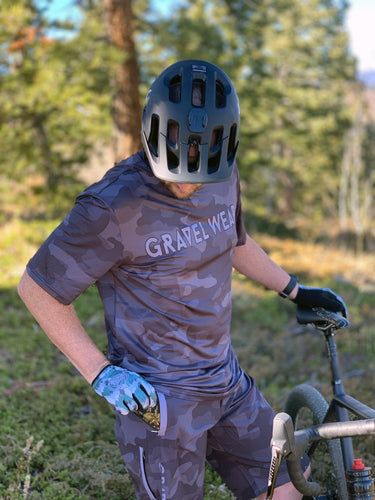 Man wearing Gravel Ride Light Jersey Camo and shorts